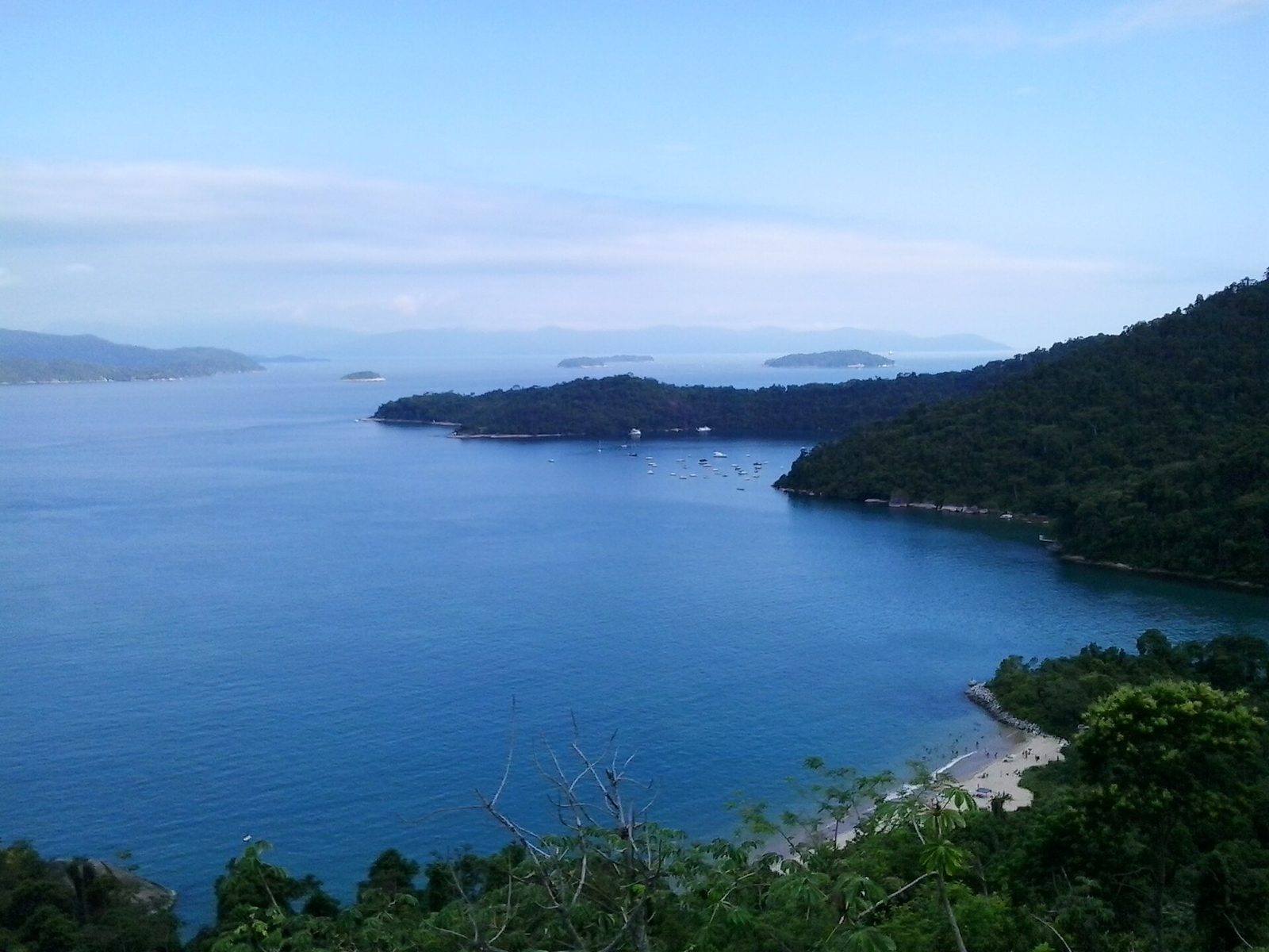 An aerial view over the Baía da Ilha Grande and its scatter of forested islands, the bay the coast road traces for much of the drive.