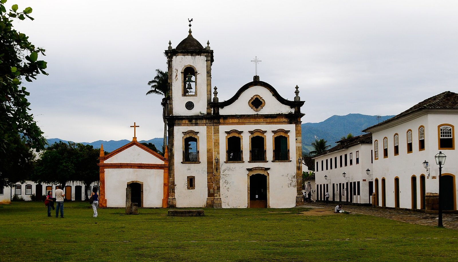 The Igreja de Santa Rita, oldest of Paraty's four churches, standing white above the harbor with the green Serra do Mar rising behind.