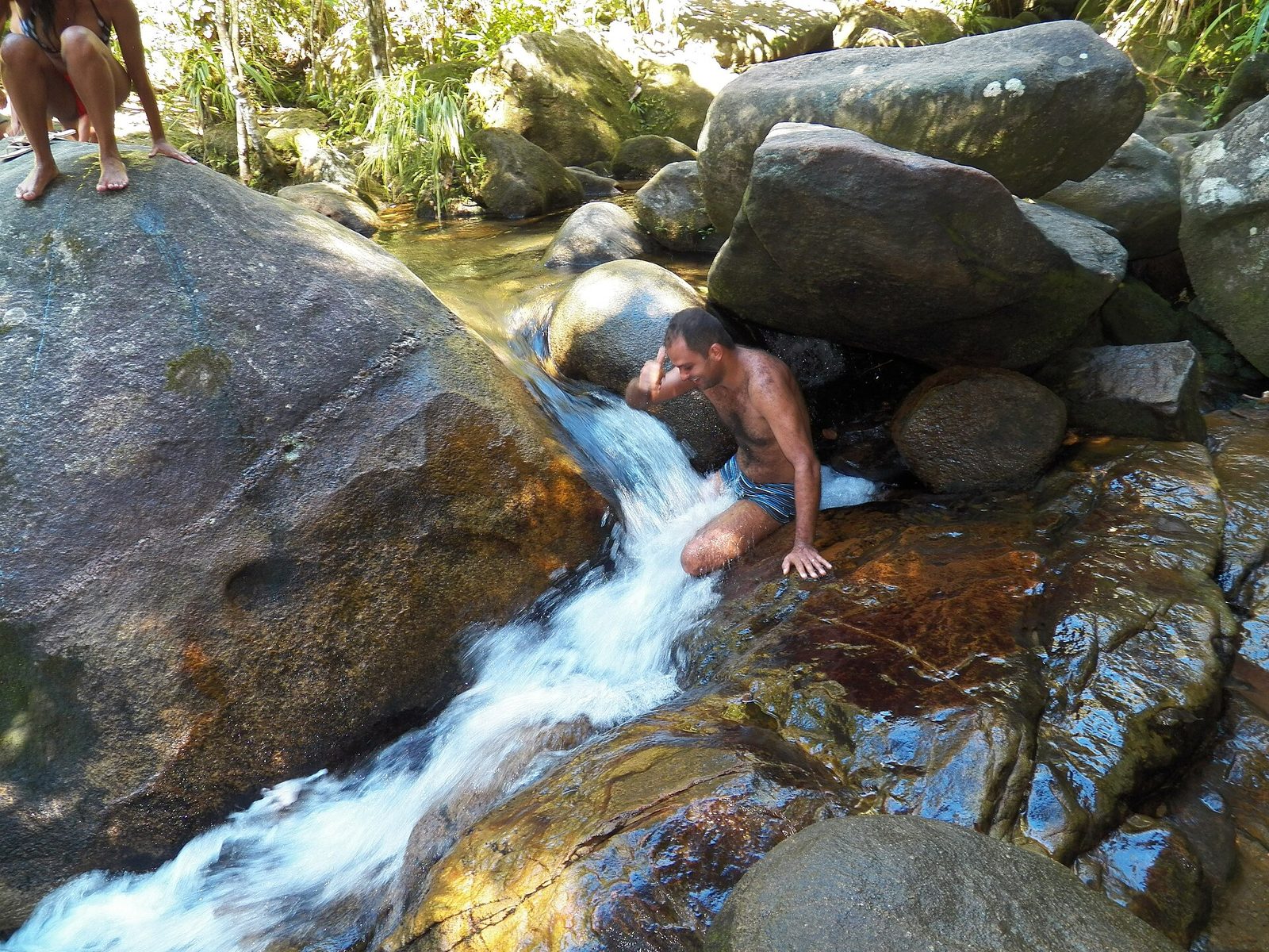Clear, calm water among the granite boulders of the Cachadaco natural pool, sheltered from the open sea.